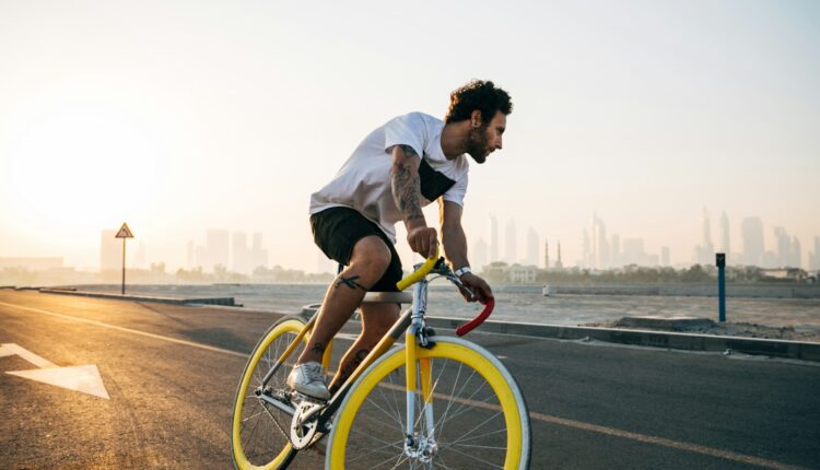 man riding bicycle on road during daytime